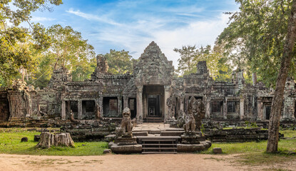 Guarded by statues entrance to ancient hindu Preah Khan khmer  ruined temple hidden in jungles, Angkor Archaeological Park, Siem Reap, Cambodia