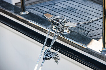 Cleat hitch securing rope on modern sailboat deck