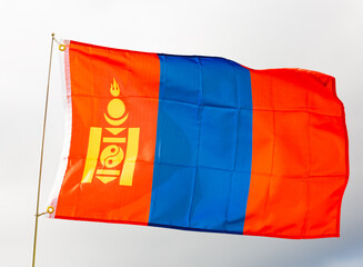 Flag of mongolia flying proudly in wind with sky as background