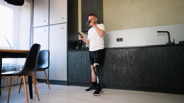 A Man Amputee with Prosthetic Leg Enjoying Coffee And Use Phone After Rehabilitation
