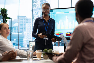 PR team presenting infographics and digital marketing insights for growth, showcasing the impact of recent campaigns and outlining plans for future development initiatives in workspace.