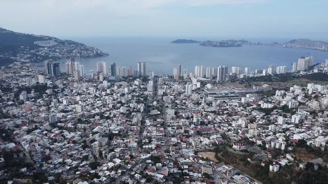 Aerial view overlooking the coast of Acapulco towards the mountains.