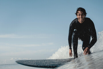 Surfer smiling having a great time catching waves