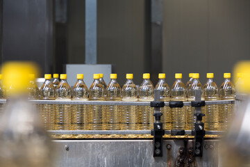 white vinegar Bottles on a conveyor belt in a production facility