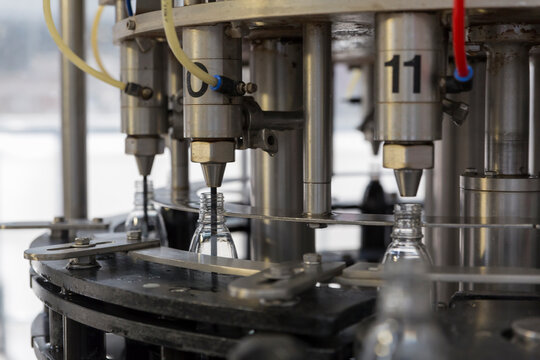 Bottling machine filling plastic bottles in a production line