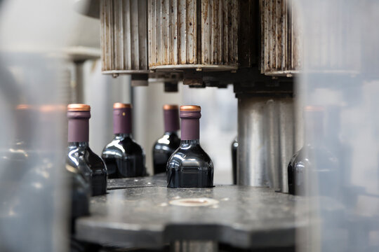 Bottling machine sealing Vinegar bottles on a production line