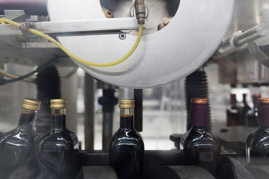 Bottling machine sealing Vinegar bottles on a production line