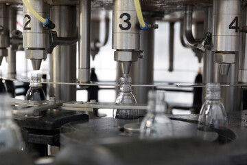 Bottling machine filling plastic bottles in a production line