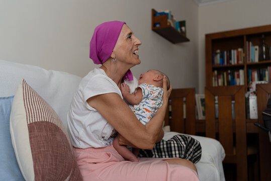 Grandmother holding crying newborn grandson