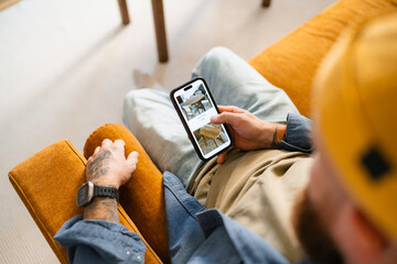 A man uses a mobile phone at home
