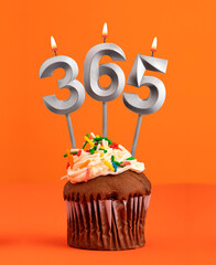 Number 365 in the form of candles on orange background.