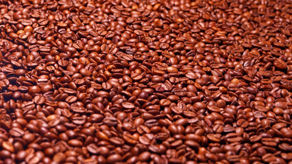 This image captures a close-up view of aromatic roasted coffee beans, emphasizing their rich color and texture, perfect for coffee enthusiasts and modern design lovers.