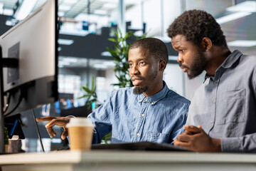 Financial advisor and colleague discussing resource allocations and budget planning in a corporate...