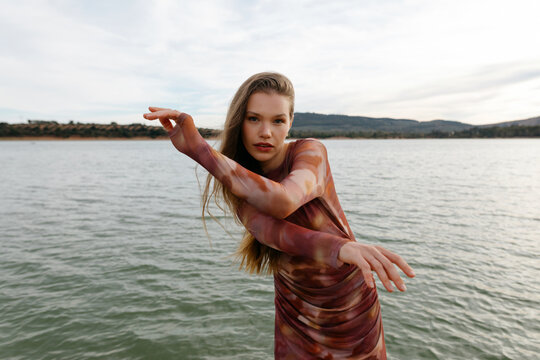 Model dancing near lake