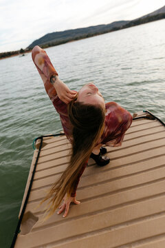 Model leaning on hand on pier