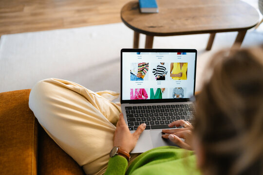A woman uses a laptop at home