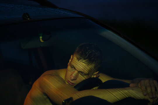 A guy in a car at night