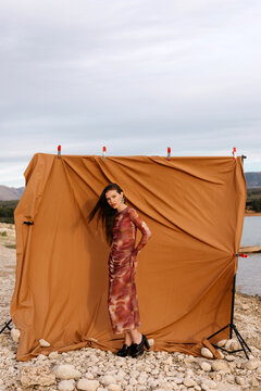 Stylish woman in heels on pebbles
