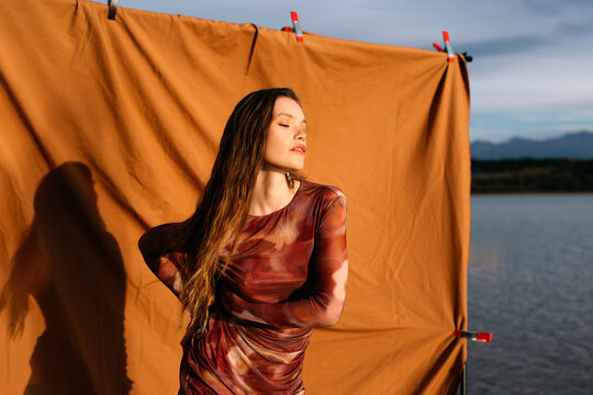 Sensual model at backdrop in sunset
