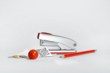 Abstract still life with stapler, pencil, coins and crumpled receipt
