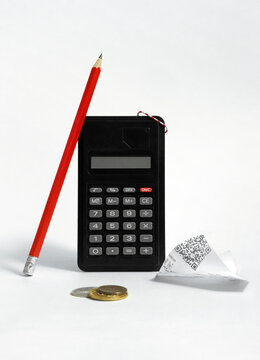 Abstract still life with calculator, pencil, coin and crumpled receipt