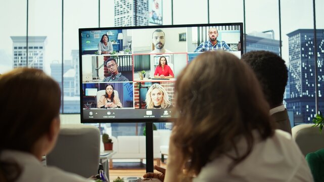 General manager starts a meeting on online videoconference call in the boardroom, discussing about updates with his staff. Business associates reviewing financial planning for growth. Camera B. - Powered by Adobe
