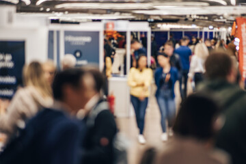 Abstract blurred people at exhibition hall of expo event trade show. Business convention show or...