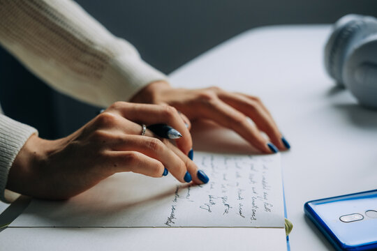 Close-Up of Hands Journaling in Notebook