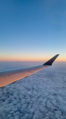 Obraz premium Sunset sky on airplane, plane window, evening flight for relax in holiday