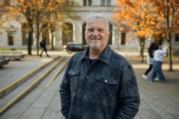 Smiling Man Outdoors in Urban Autumn Setting