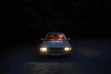 A cinematic shot of a car and the woman inside.