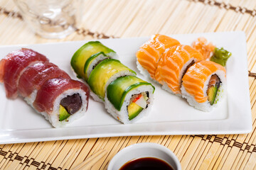 Set of rolls with salmon, avocado, tuna and crab served with soy sauce