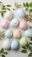 Colorful Easter eggs with speckles arranged among spring flowers and leaves