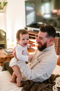Dad putting clothes on toddler