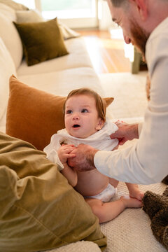 Father dressing baby