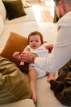 Father dressing baby