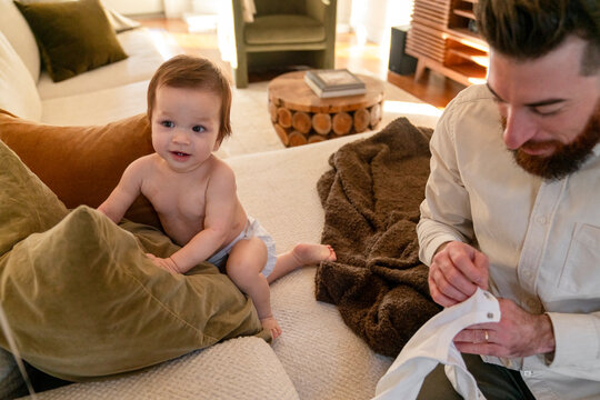 Father dressing baby