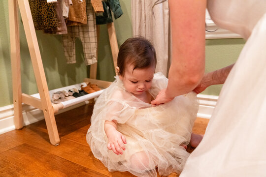 Mother dressing baby 