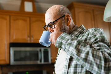 A man drinks from a mug