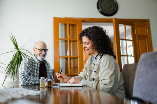 The doctor talks to the patient at home