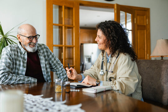 The doctor talks to the patient at home