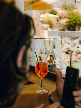 Enjoying a refreshing cocktail while relaxing by the seaside bar