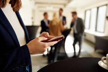 Businesswoman texting on her phone