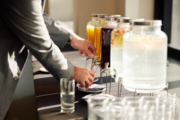 Pouring juice from a dispenser