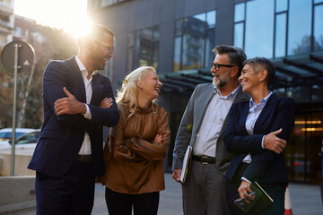 Coworkers are having a cheerful conversation outside