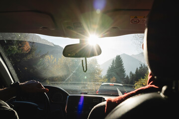 Scenic Drive with Sunlight Streaming Through Windshield