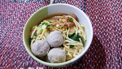View of chicken noodles in a bowl with meatball balls in it