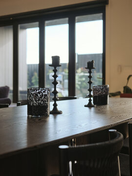 Elegant dining setup with candles and stylish decor in modern interior