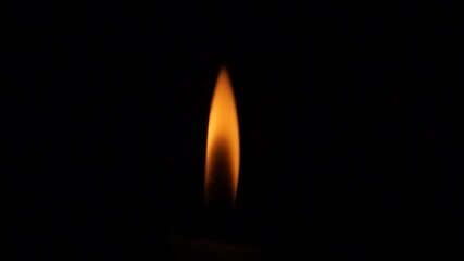 a small flame in the darkness for background