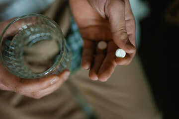 Man's hands with pills